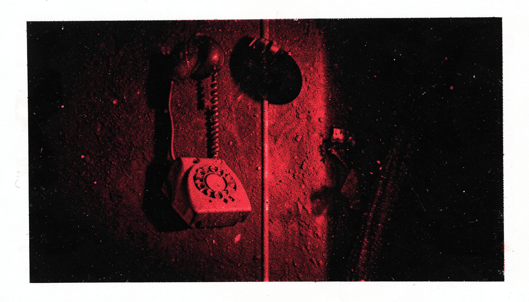 A two-ink risograph print in black and blood red showing a vintage rotary phone hanging on a dimly lit wall, with deep shadows and a tense, eerie atmosphere.