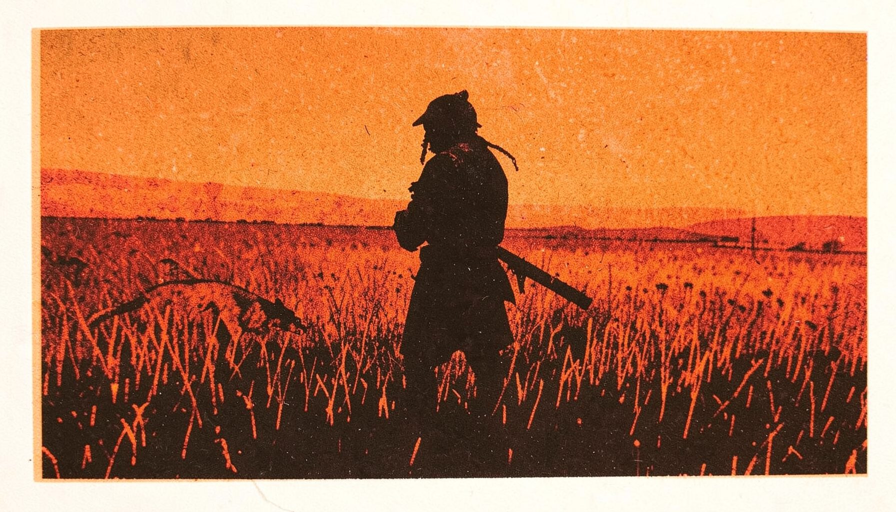 A two-ink risograph print in burnt orange and deep brown showing a Comanche warrior in silhouette against a vast prairie landscape, with a faint predator-like shimmer in the tall grass.